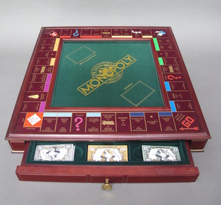 A Franklyn Mint collector's Monopoly game contained in a mahogany case fitted a drawer containing counters and cards etc  22"