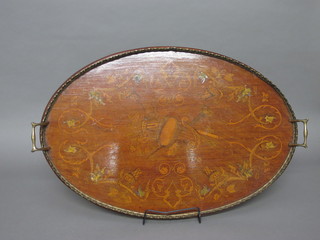 An oval inlaid mahogany tea tray decorated musical trophies with brass gallery 26"