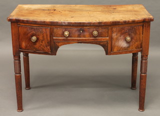 A Georgian mahogany bow front dressing table with crossbanded  top, fitted 1 long and 2 short drawers, raised on ring turned  supports 40"  ILLUSTRATED