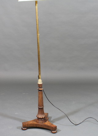 A William IV mahogany and brass pole screen with triform base, converted for use as a standard lamp