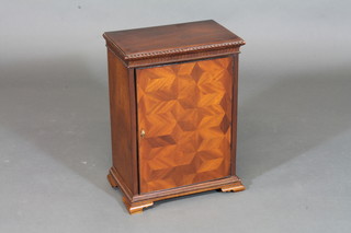 A Continental table top cabinet fitted shelves and numerous  drawers enclosed by a parquetry panelled door, raised on bracket  feet 13"