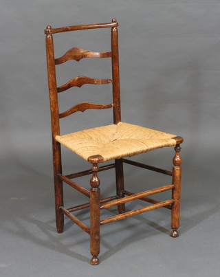 An 18th Century elm ladderback chair with woven rush seat,  raised on cabriole supports