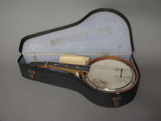 An 8 stringed banjo, with 9" drum, complete with fibre carrying case