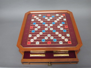 A Franklyn Mint collector's Scrabble board contained in a mahogany frame complete with score pads, letters etc, 19"