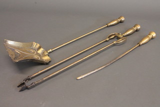 An Art Nouveau brass 3 piece fireside companion set with  shovel, poker and tongs