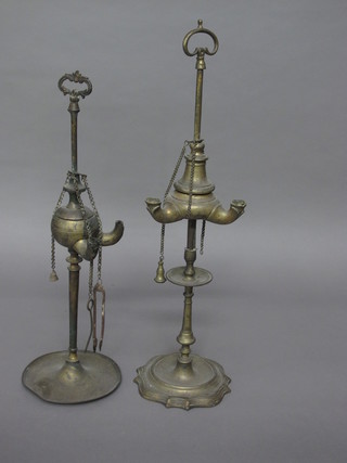 2 Eastern brass oil lamps raised on circular bases