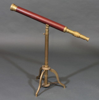 A reproduction leather and brass telescope complete with tripod