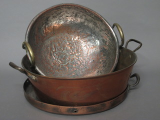 A circular copper pan 14", a brass twin handled preserving pan 14 1/2" and a circular brass twin handled pot