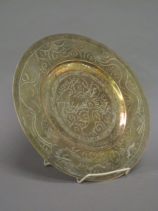 An Oriental circular engraved metal charger 12"