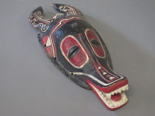 A carved mask in the form of a mythical beast