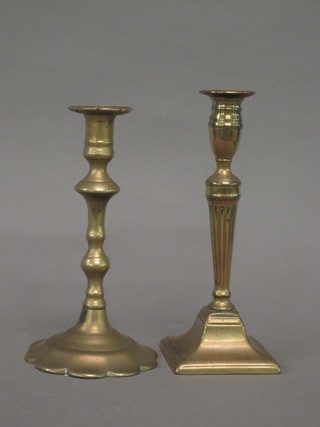 An 18th Century brass petal base candlestick marked EK 8" and a brass candlestick with ejector