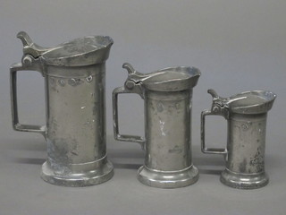 3 Continental pewter spirit measures with hinged lids