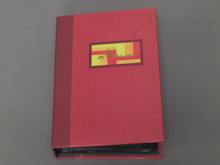 A red loose leaf album of postcards - animals, aircraft etc