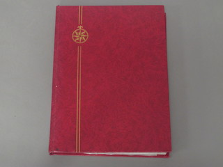 A red stock book containing a collection of Commonwealth  stamps
