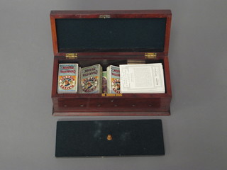 A collection of cigarette cards contained in a rectangular  mahogany box with hinged lid