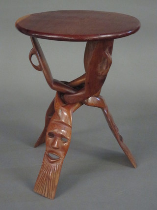 A circular Eastern hardwood table raised on a folding stand 13"