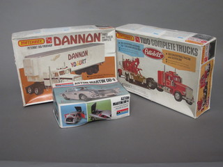 A Matchbox model PK7105 Tow Complete trucks, 1 other  PK7104 Dannon and a Monogram model of an Aston Martin DB-4