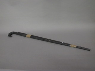 A turned ebony walking stick, the handle in the form of an  elephants head and 1 other