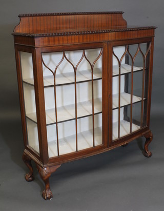 A Chippendale style bow front display cabinet with raised back,  the interior fitted shelves enclosed by astragal glazed panelled  doors 44"