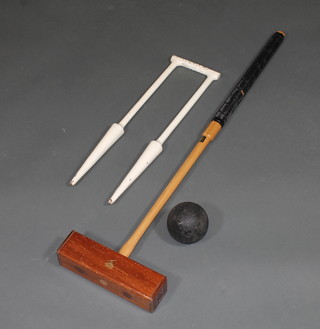 A Jo Hogan croquet mallet together with a ball and an iron hoop marked Townsend