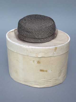 A lady's brown vintage pill box hat