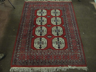 A contemporary red ground Bokhara carpet with 8 octagons to  the centre 69" x 49"