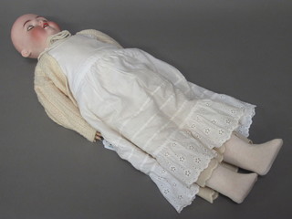 A German porcelain headed doll with open mouth with teeth,  open and shutting eyes, the head incised AB 1362 Made in  Germany