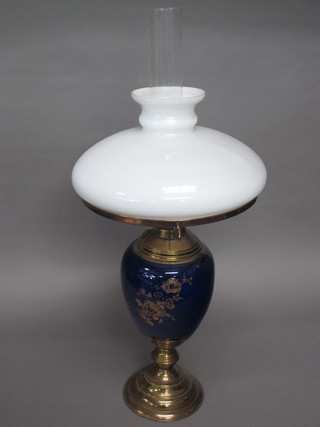 A blue glazed porcelain oil lamp with gilt metal mounts complete  with glass chimney and shade