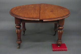 A Victorian oval mahogany extending dining table, raised on turned supports 48"