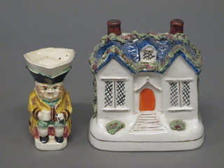 A pottery Toby jug 3" and a Staffordshire flat back figure in the  form of a cottage 5"