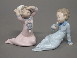 2 Lladro figures of seated boy and girl 7"