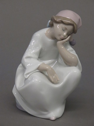A Lladro figure of a seated lady wearing a night cap, the base impressed B-24 Feb, 6"