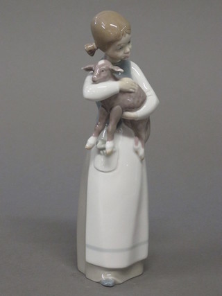 A Lladro figure of a standing girl with lamb, the base incised  B-16 8 1/2"