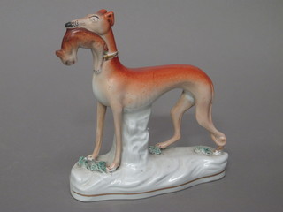 A 19th Century Staffordshire figure of a standing greyhound with  hare 7 1/2", black leg f and r,
