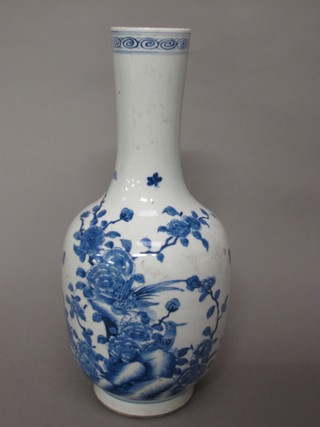 A blue and white Oriental club shaped vase decorated birds amidst flowering branches, the base with numerous marks 18"