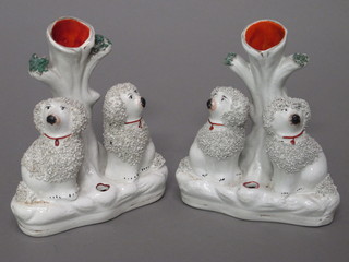 A pair of 19th Century Staffordshire spill vases in the form of seated poodles 5"