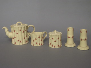 A Wedgwood bamboo finished 3 piece tea set comprising teapot, sugar bowl and milk jug, together with a matching pair of  candlesticks 4", decorated fuscias