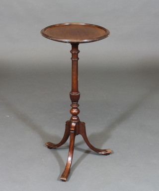 A circular Georgian style mahogany wine table, raised on pillar and tripod supports 12"