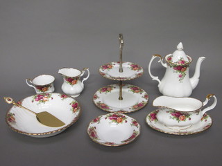 A 50 piece Royal Albert Old Country Rose patterned tea/dinner service comprising circular platter 13" - second, 6 dinner plates  12", 6 pudding bowls 6 1/2", sauce boat and stand, coffee pot,  cream jug, 4 coffee cans and 4 saucers, sugar bowl, circular  bowl 9", 2 tier cake stand, cake knife, circular jar 3", twin  handled bread plate 9", 6 tea plates 6 1/2", 6 cups and 6 saucers,  teapot, sugar bowl and milk jug - chip to rim