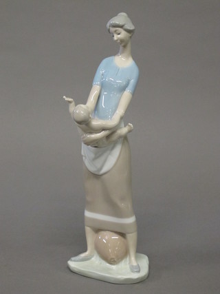 A Lladro figure of a mother and child, base incised 26 13"
