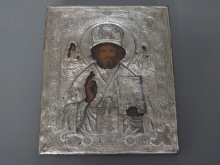 An Icon painted panel with silver frame depicting a standing priest 10" x 8 1/12"