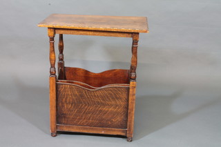 A rectangular oak occasional table, the base incorporating a Canterbury, raised on turned and block supports 24"
