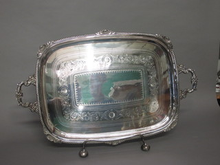 An oval silver plated twin handled tea tray with gadrooned border and engraved decoration 24" and a silver plated stand