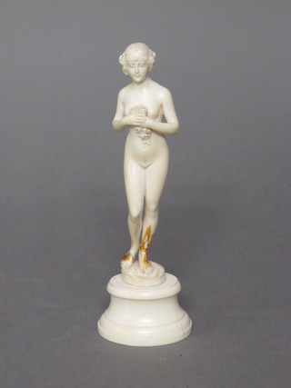 A carved ivory figure of a standing lady, raised on a marble  base, legs f and r,