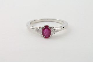 An 18ct white gold dress ring set a ruby and 2 diamonds to the shoulders