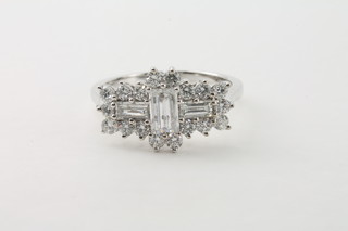 A lady's 18ct white gold dress ring set 3 baguette cut diamonds supported by diamonds, approx 1.22ct