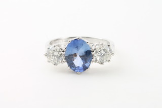 A lady's 18ct white gold dress ring set an oval cut sapphire  supported by 2 diamonds, approx 2cts/1.15cts  ILLUSTRATED