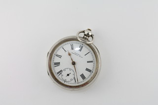 An open faced pocket watch by Waltham contained in a silver case