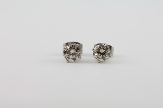 A pair of 14ct white gold diamond ear studs, approx 1.20ct in  total,