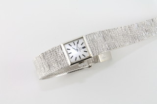 A lady's Omega wristwatch contained in a 9ct white gold case with integral bracelet